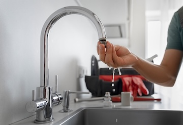 One of our plumbers fixing a sink.